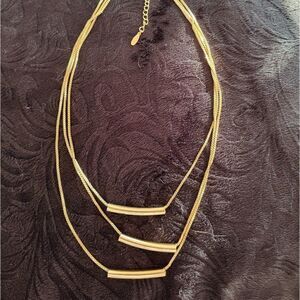 Gold dangling necklace with 3 chains